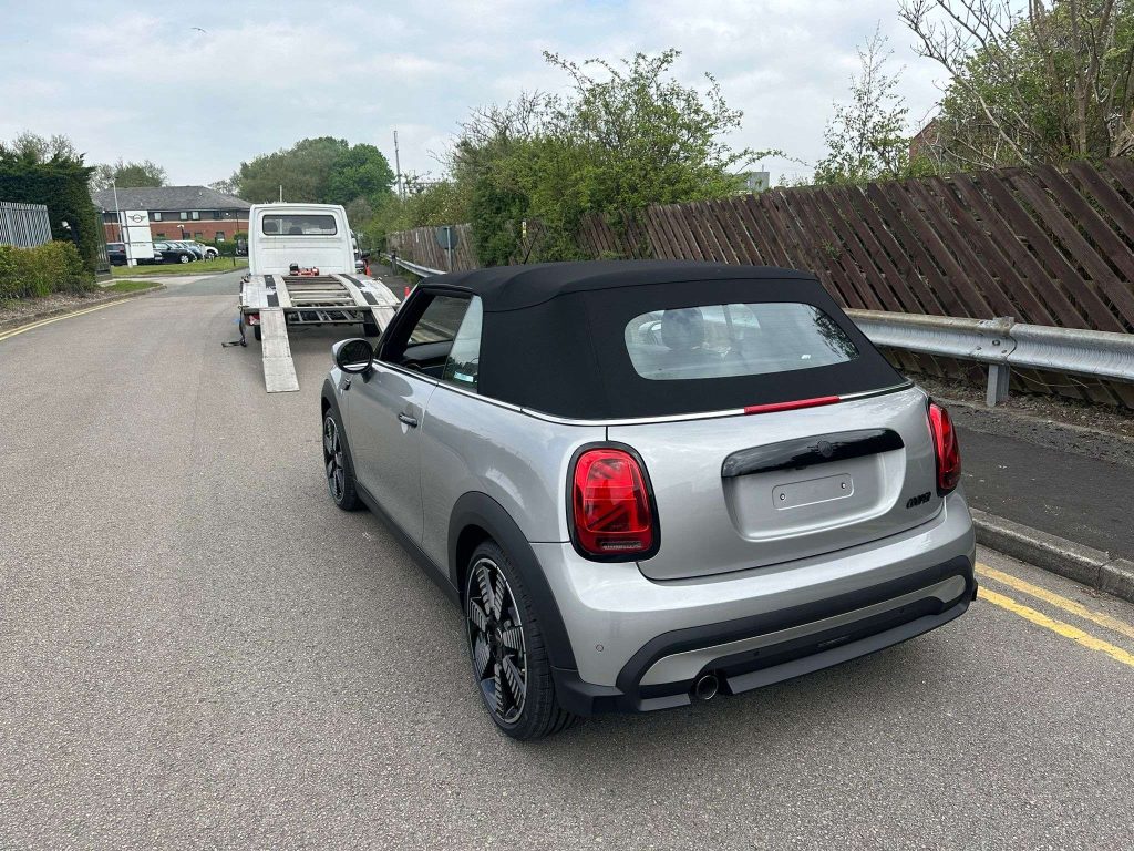 Silver convertible car with a black soft top collected at bmw liverpool by us