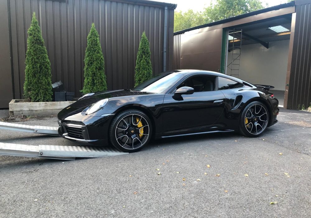 Black Porsche 911 Turbo being loaded by AK Car Transport for nationwide vehicle delivery